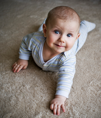 Baby sitting on freshly cleaned beige carpet after professional carpet cleaning in Sydney by Tuft & Weave