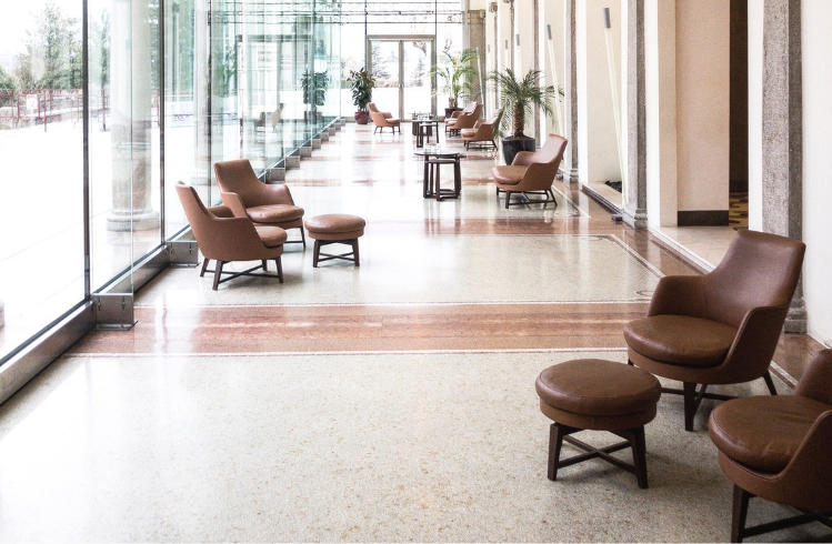 Sun filled foyer with brown leather armchairs