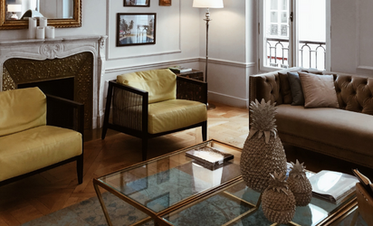Sun filled lounge room with yellow armchairs and beige sofa