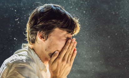 Man holding his nose