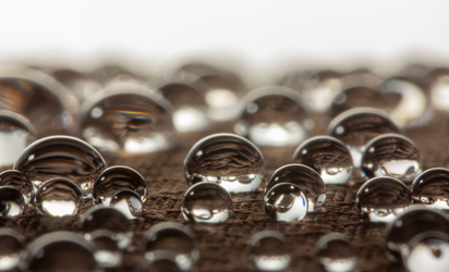 Water molecules up close on beige carpet