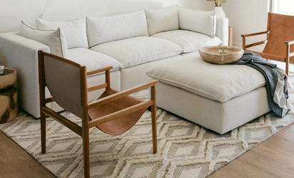 Cream sofa, brown armchair and beige ottoman