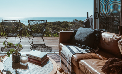 Bright and open room overlooking the water with ta leather lounge