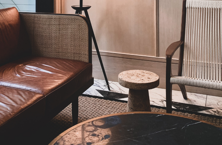 Brown leather lounge on beige rug