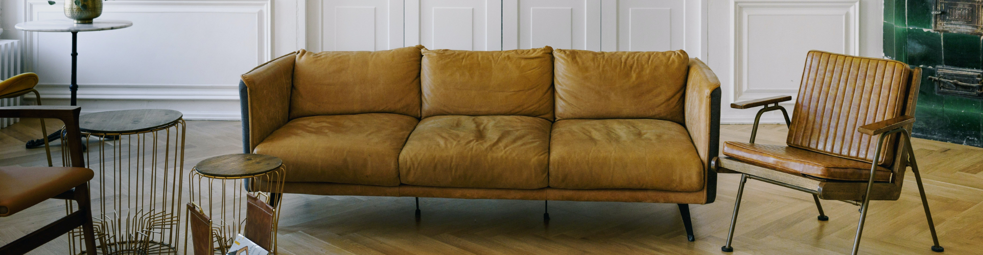 Mustad sofa and tan leather armchair